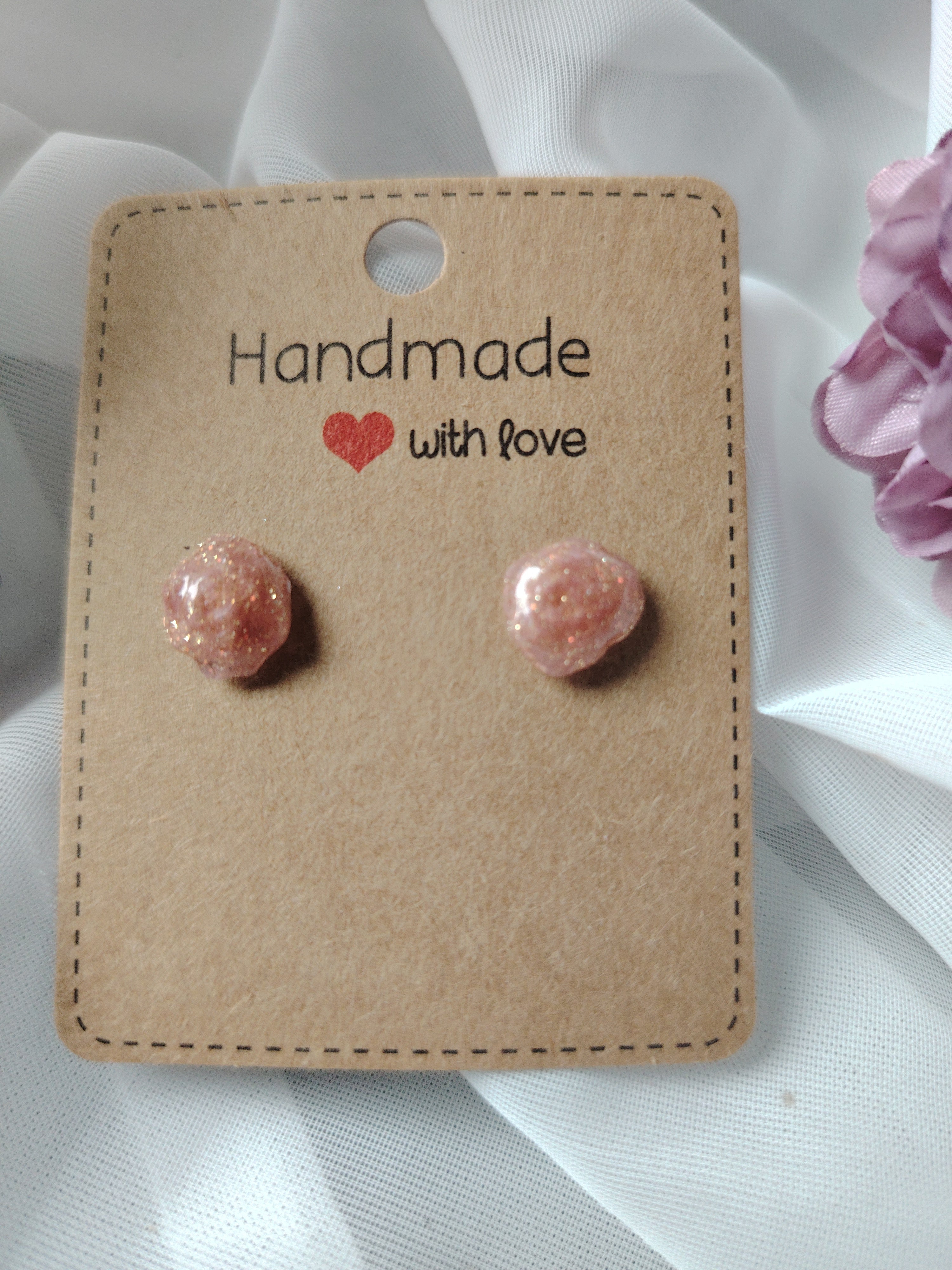 Small pink glitter rose stud earrings coated with UV resin
