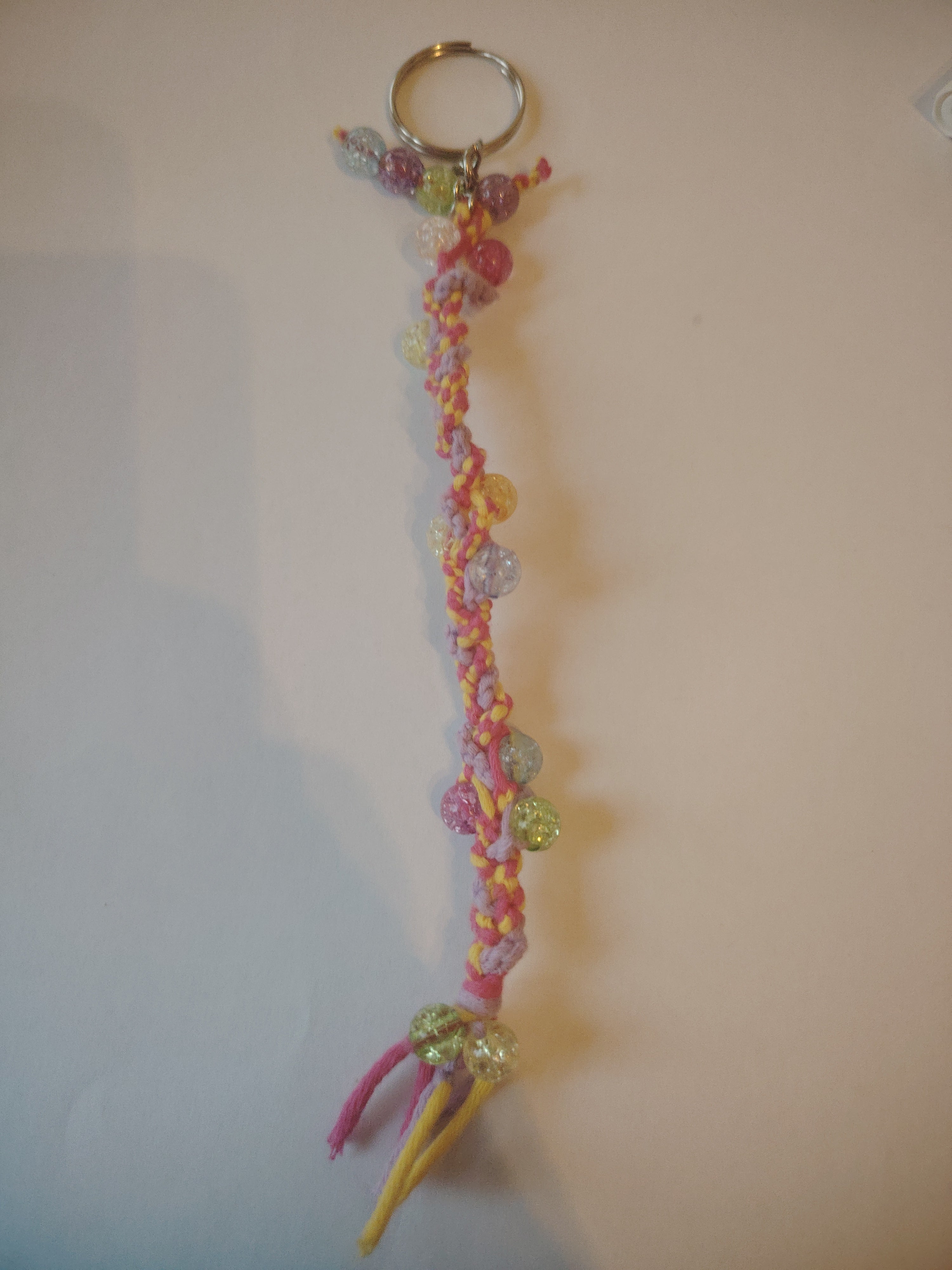 Colorful key ring made using knotting techniques and glass beads