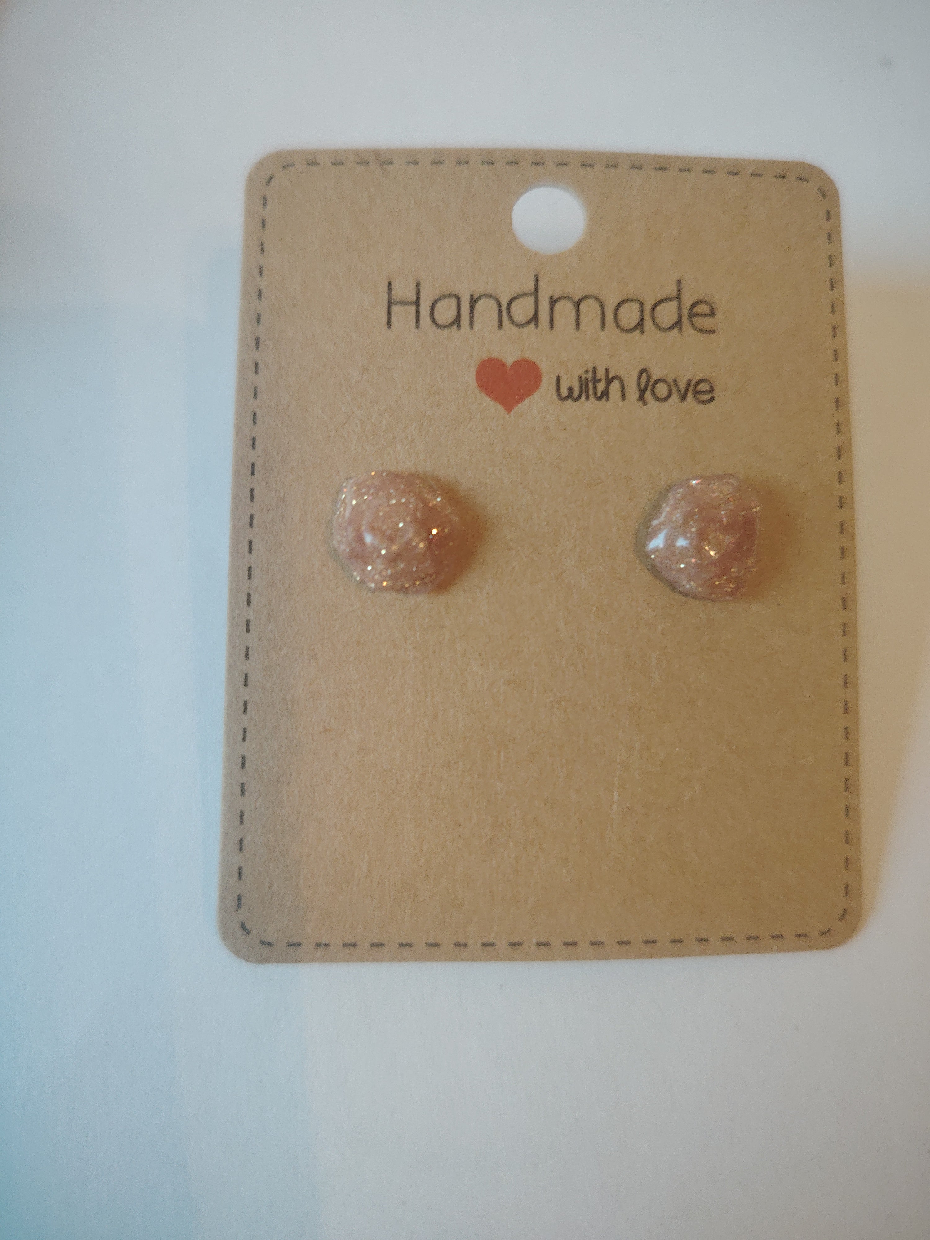 Small pink glitter rose stud earrings coated with UV resin