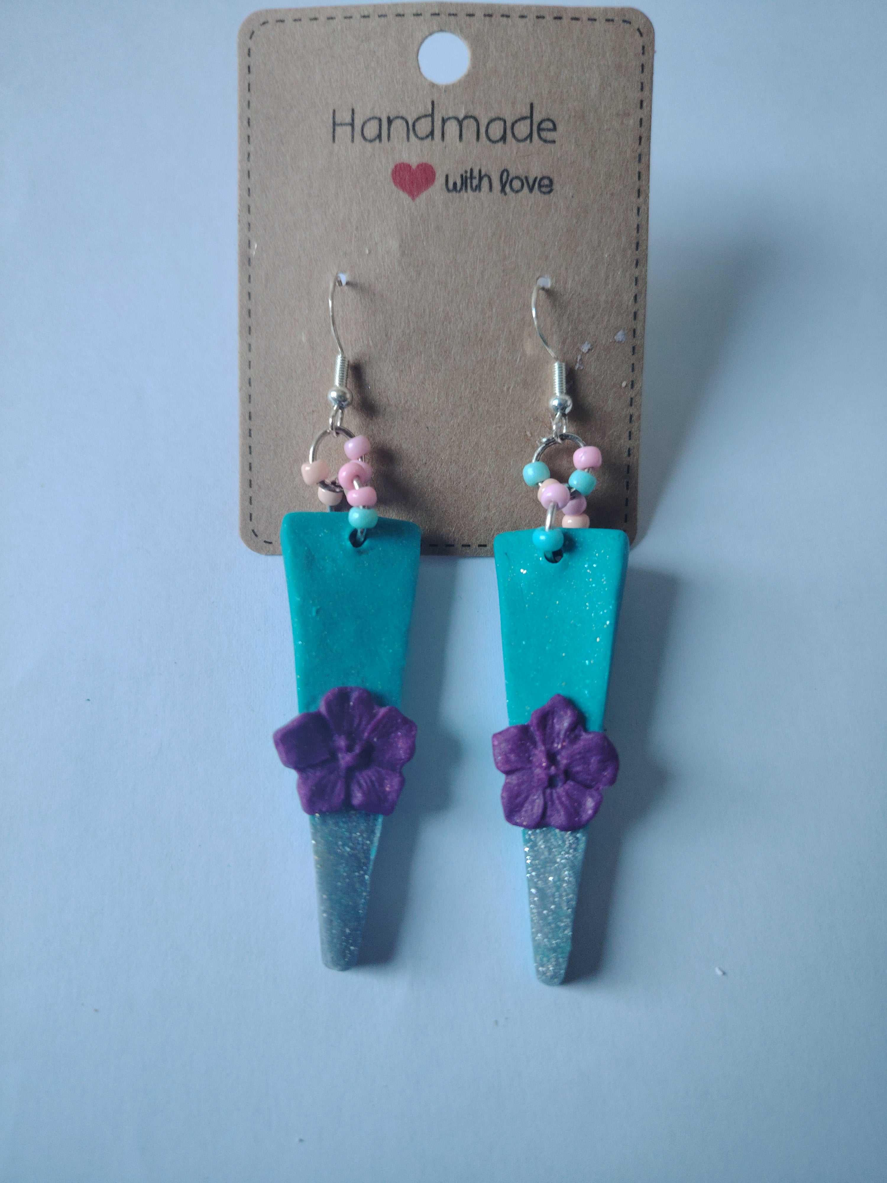 Earrings in an elongated triangular shape (turquoise glitter, silver glitter with cute little purple flowers)