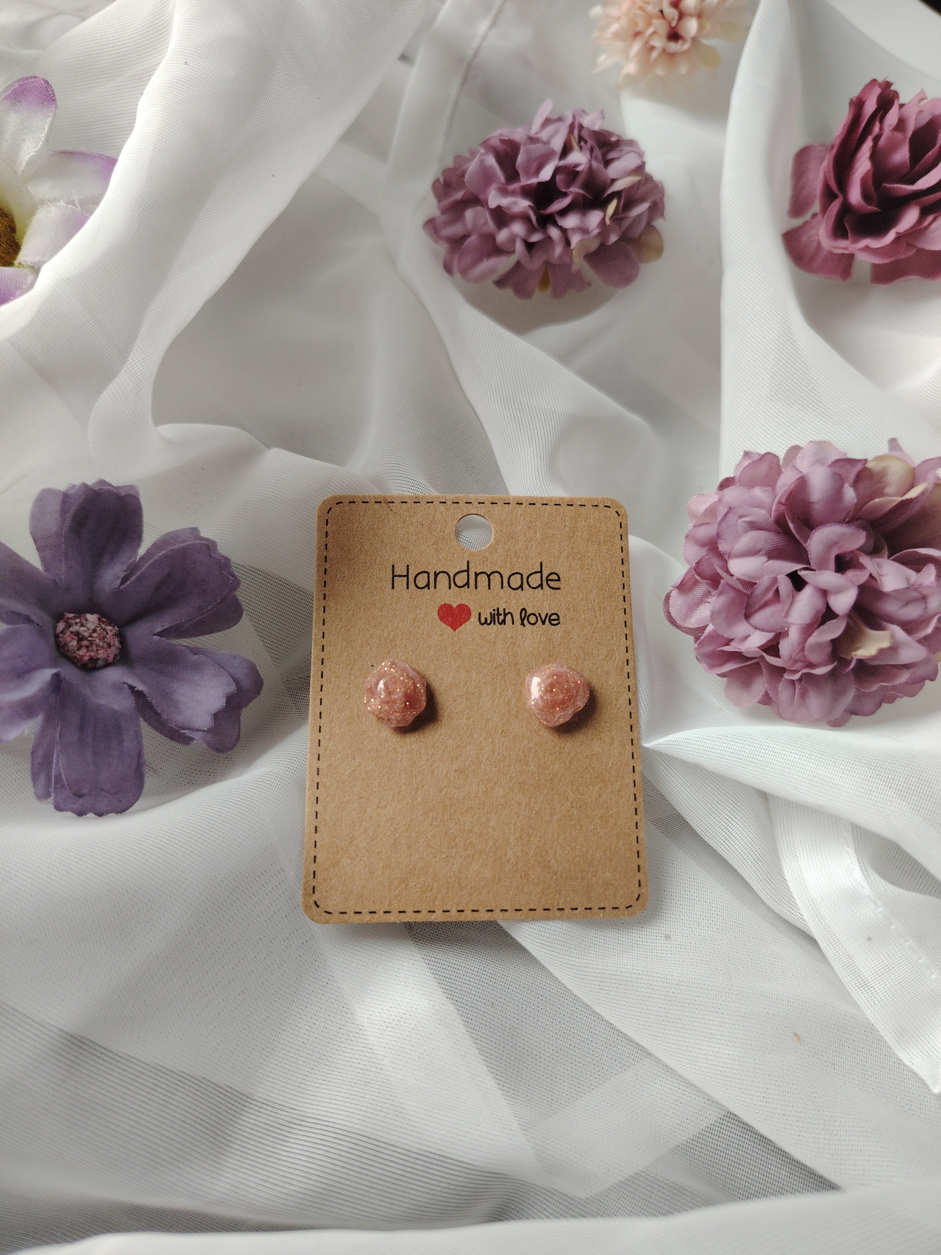 Small pink glitter rose stud earrings coated with UV resin